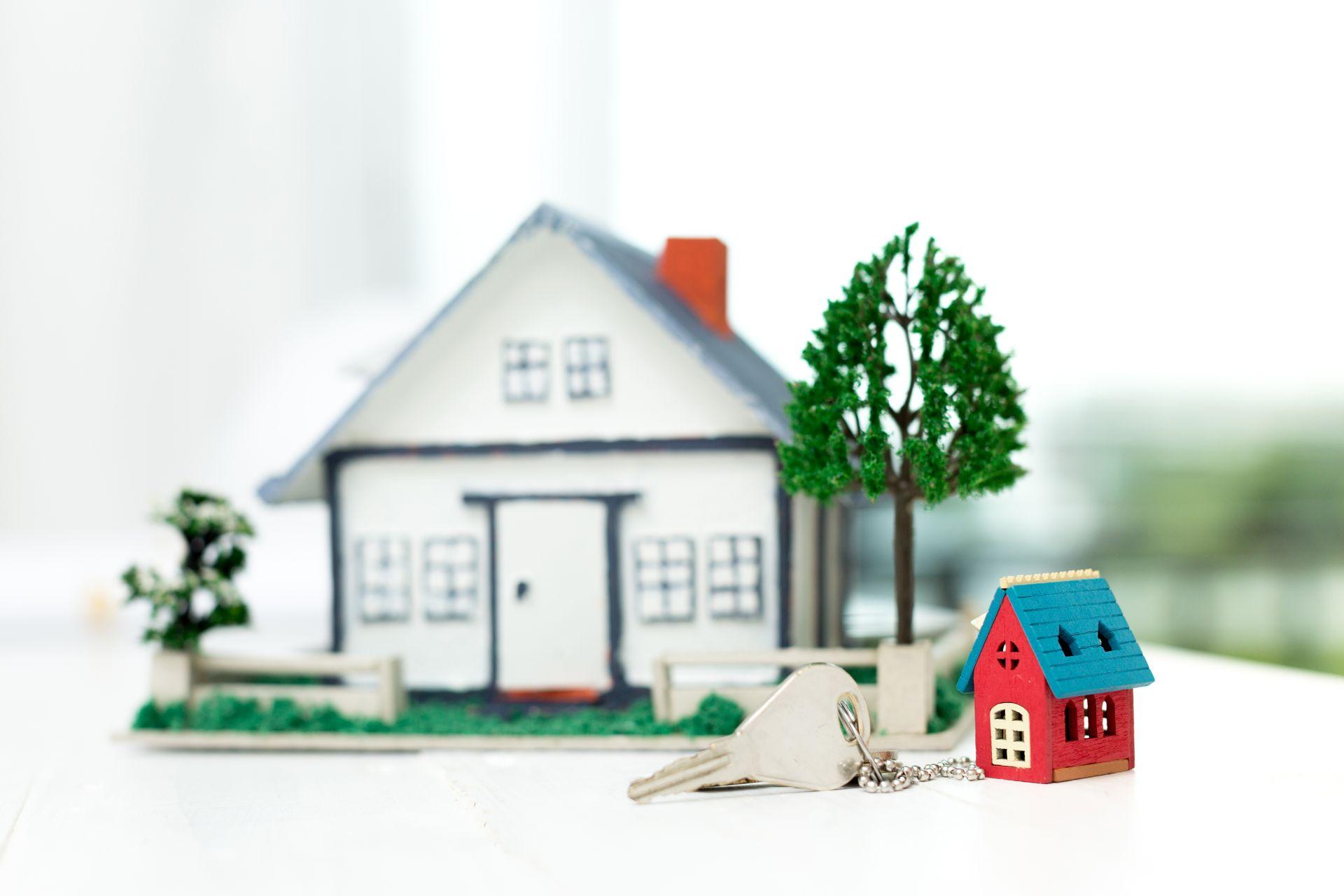 real estate agent with house model and keys