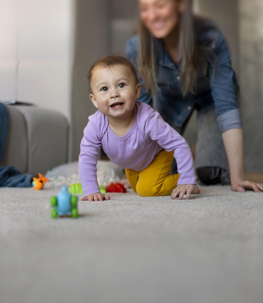 adorable baby playing with toy home floor