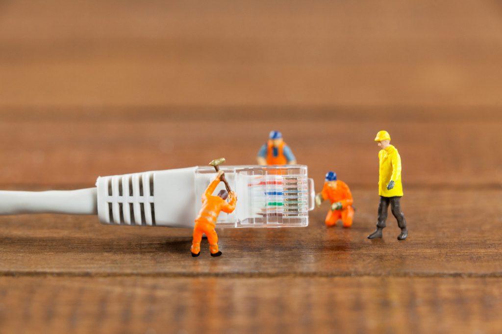 miniature engineer workers working with lan cable (1)