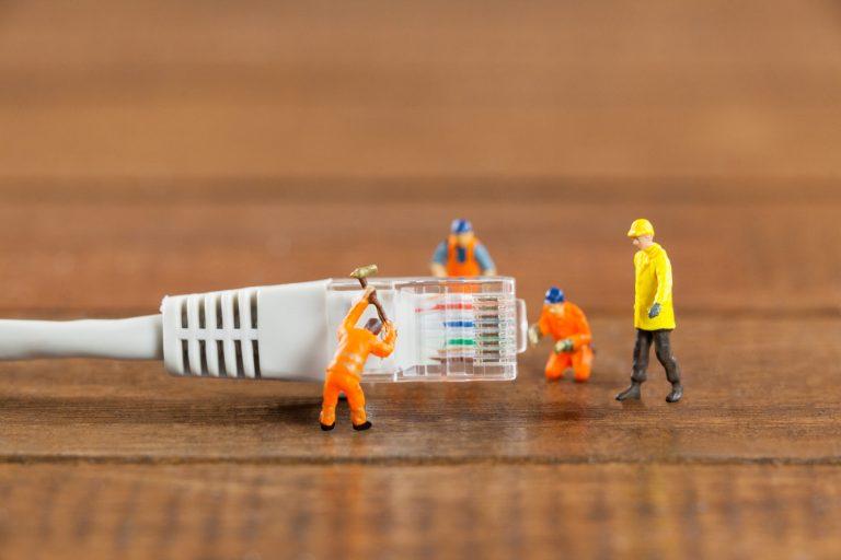 miniature engineer workers working with lan cable (1)
